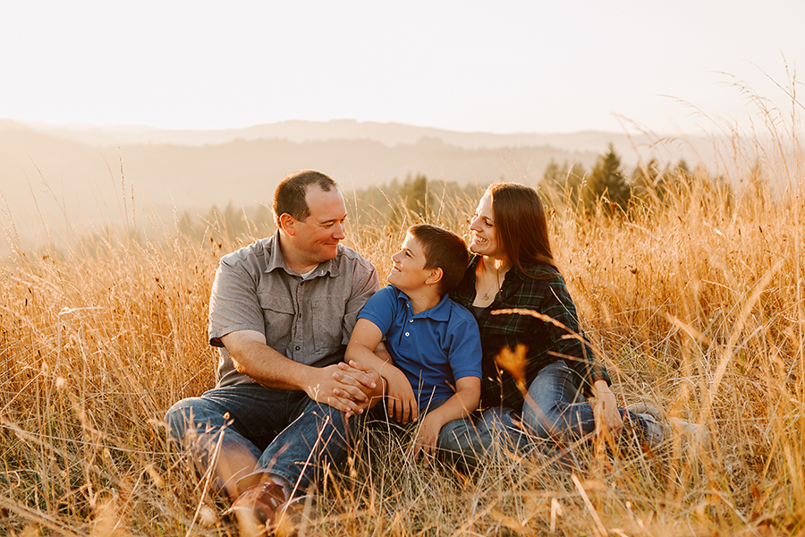 Family sitting in a field at Fitton Green Natural Area Corvallis, OR