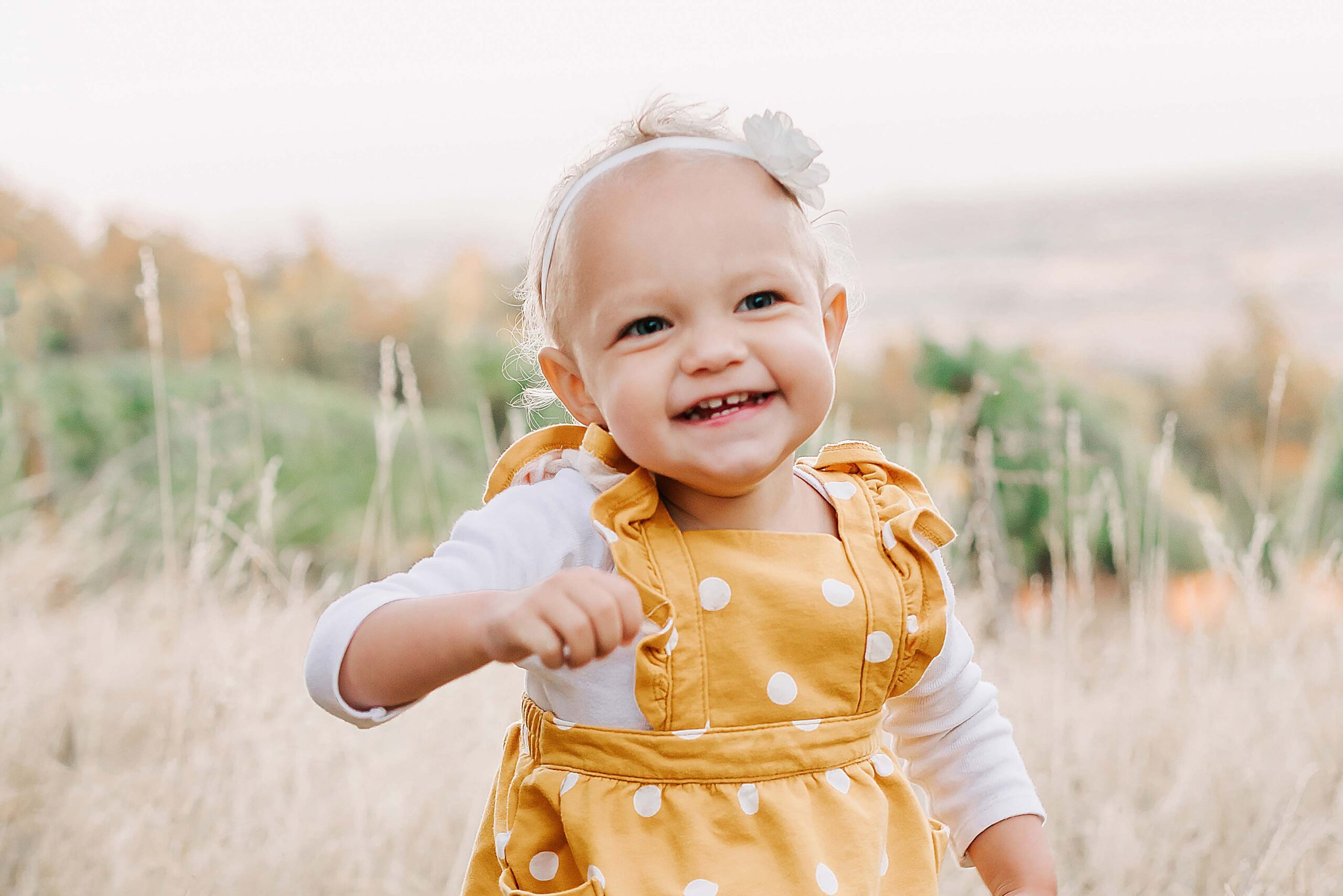 Toddler girl having fun at pumpkin patch Salem Oregon