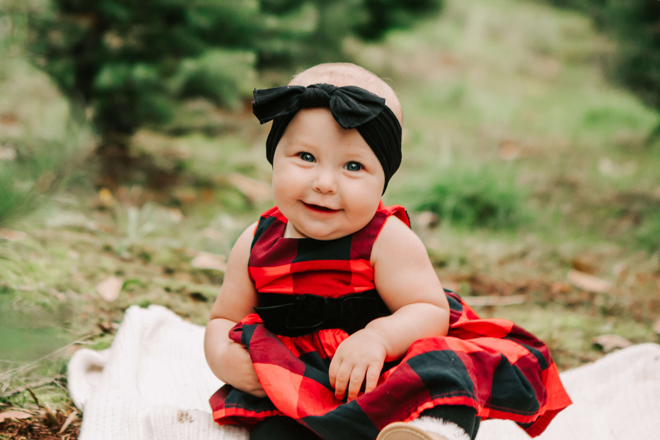 Baby sitting on a blanket at a Christmas tree farm-Skyline Christmas Tree Farm Salem, OR