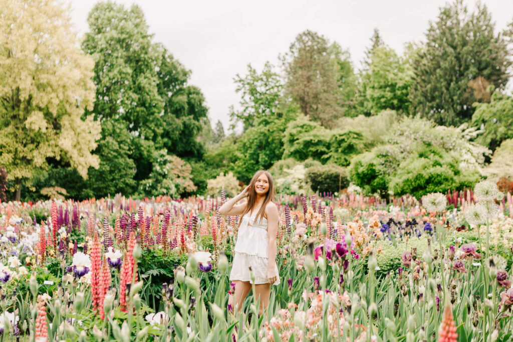 A high school senior poses at Shreiners Iris Gardens for senior photos