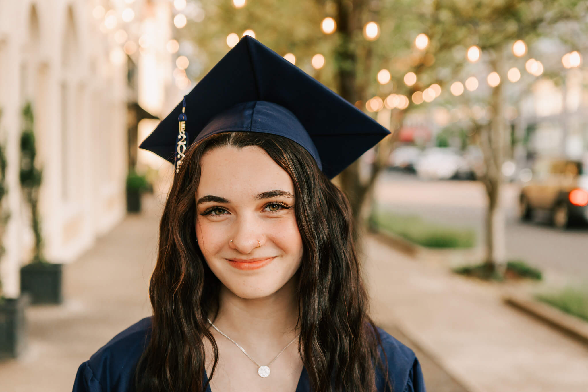 High school senior poses in West Albany High School cap and gown downtown Albany OR