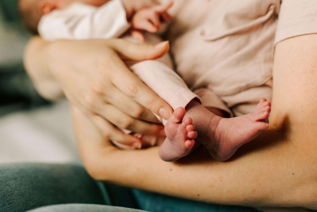 A mother cradles her newborn baby.