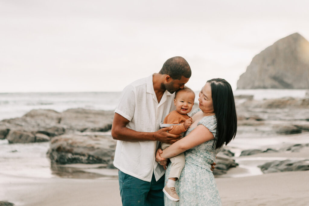 Father playing with toddler during a Jen White family photography session in Cape Kiwanda, OR