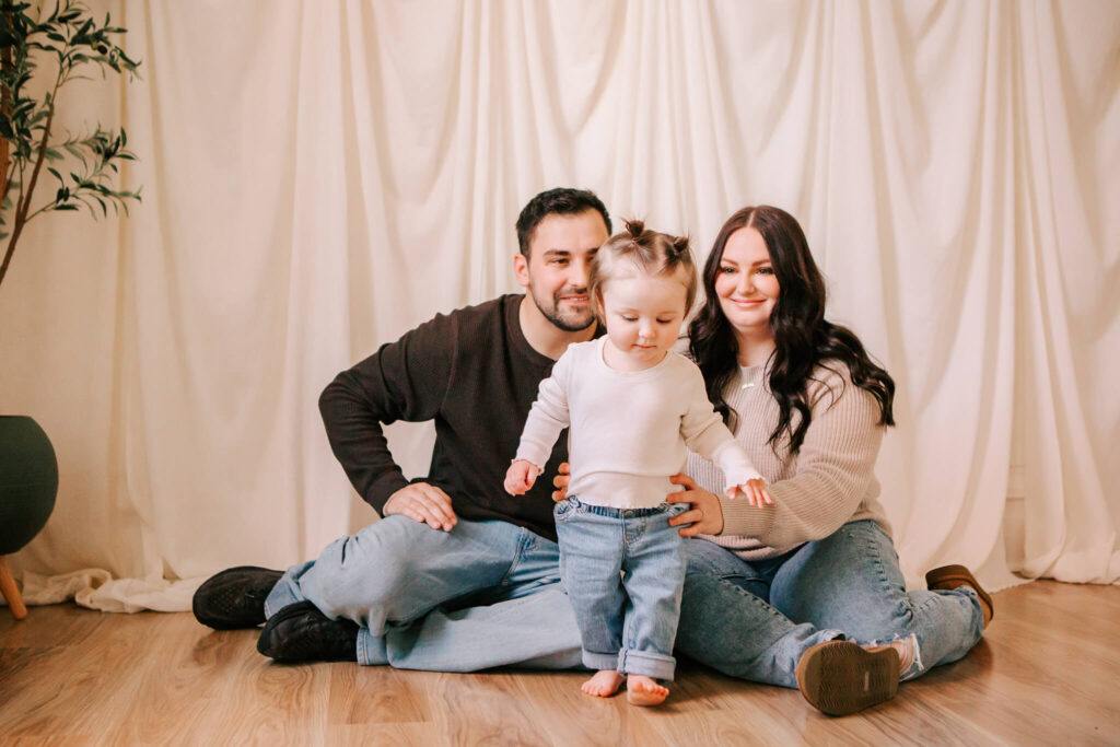 Toddler girl runs from family during family photos in Studio 22 salem