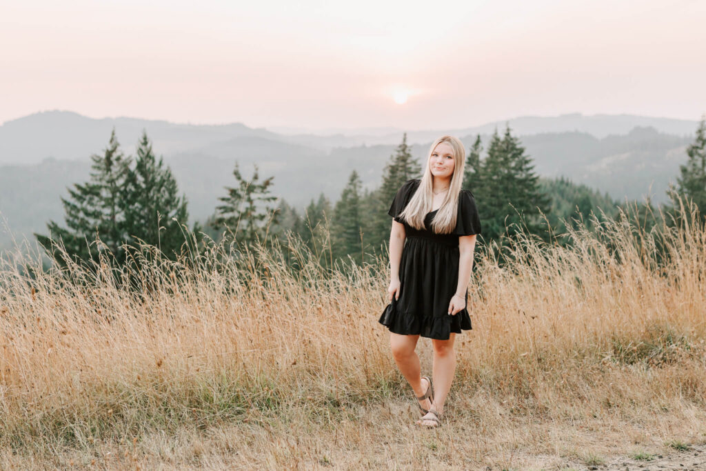 high school senior girl stands in tall grass at fitton green in corvallis oregon