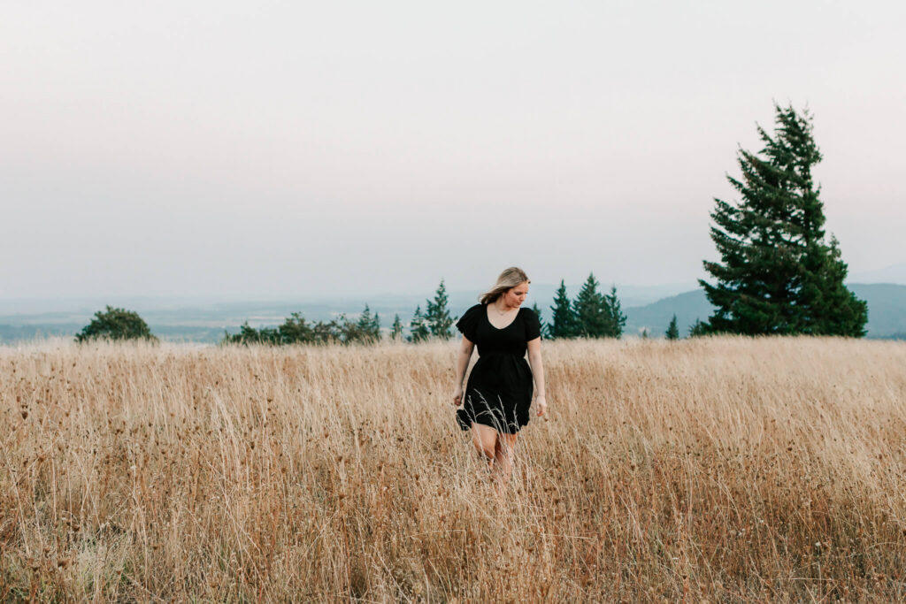 senior girl in golden field wearing black dress